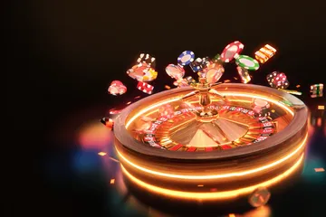 A glowing roulette wheel with cascading chips, symbolizing the engaging live and instant-win games available on L85.