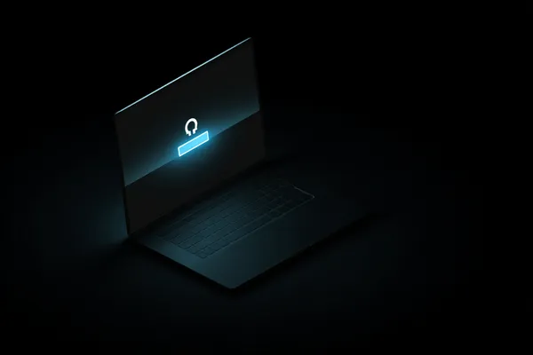 A laptop glowing with a bright login prompt in a minimalistic setup, symbolizing the protected access system at L85.